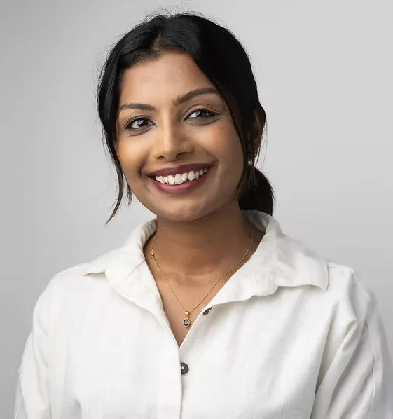 Dulari Ranasinghe in a white shirt, smiling.